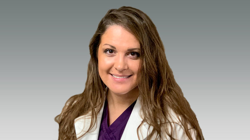 Emily Hipp in white coat smiling